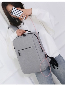 Detail view of grey business laptop backpack with USB charging port and side pocket