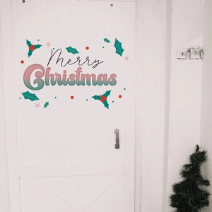 Close-up of Merry Christmas wall decal with pink gradient letters and holly decor