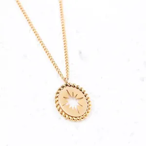 Elegant gold oval pendant necklace with hollow starburst design and rope texture