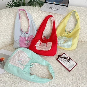 Flat lay of canvas tote bags in blue, red, yellow and mint with checkered pockets