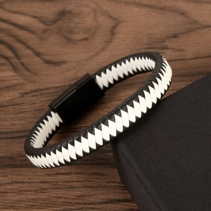 Close-up of black and white braided leather bracelet with a black magnetic clasp