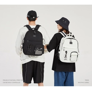 Rear view of black and beige canvas backpacks with transparent PVC pockets on models