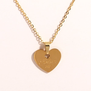 Detail of gold titanium heart necklace with Kocham cie engraving and clover connector