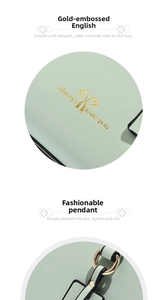 Close-up of mint green leather bag with gold heart logo and circular hanging charm