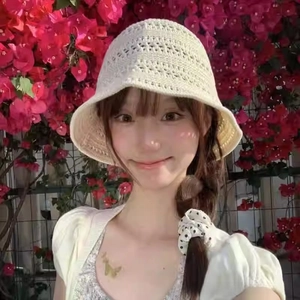 Close-up of cream crochet bucket hat showing hollow knit texture and summer design