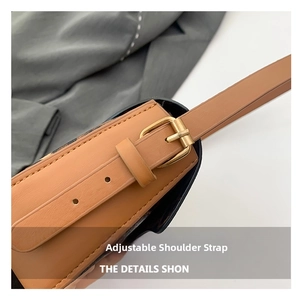 Detail of adjustable leather shoulder strap with gold metal buckle and precision holes
