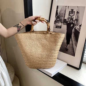Large hand-woven straw tote bag with natural bamboo handles for summer vacation