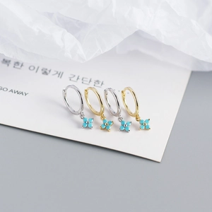 Detail of S925 silver flower hoop earrings in gold and silver finish with turquoise petals
