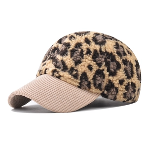 Detail of leopard print faux fur baseball cap with beige corduroy brim texture