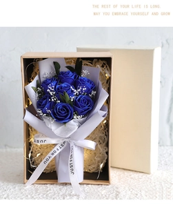 Detail of blue soap rose bouquet with LED string lights in a premium gift box