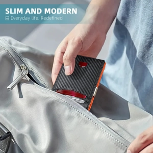 Slim carbon fiber wallet with orange lining being placed in a gray backpack pocket