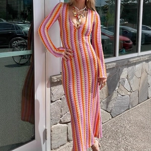 Bohemian knit maxi dress with deep V-neck and colorful chevron wave pattern on model