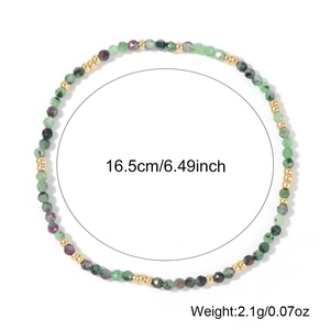 Bohemian natural stone beaded bracelet with gold metal spacers on white background