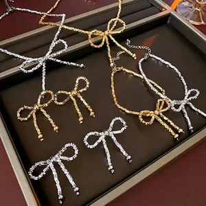 Elegant bow-shaped necklace and earring jewelry set with crushed silver texture in gold and silver