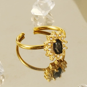 18K gold-plated stainless steel sunflower ring with dark zircon gemstone on a warm backdrop