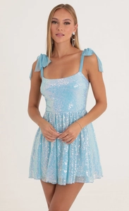 Detail of light blue sequined mini dress with elegant mesh bow tie shoulder straps