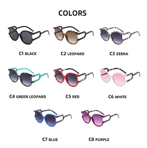 Flat lay of round fashion sunglasses in eight varied frame colors on white background