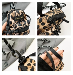 Detailed view of mini leopard print crossbody bag with fashion label and zipper detail