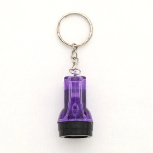 Detail of purple translucent mini LED flashlight keychain with silver metal ring