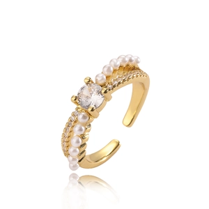 Gold plated open ring with large zircon stone and small pearls on a white background