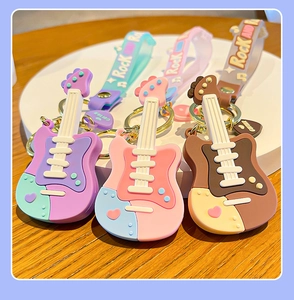 Detailed close-up of three colorful silicone guitar keychains with Rock text wristlets