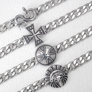Silver stainless steel Cuban chain bracelets with snake, cross, and shield charms