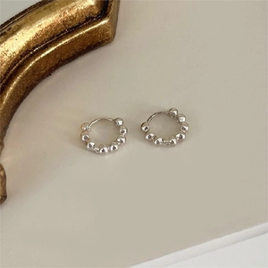 Minimalist 925 sterling silver beaded hoop earrings on an elegant white surface