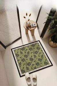 Detailed top view of grey-green square diatom mud mat with floral pattern and white border