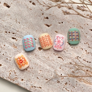 3D embossed nail art stickers with woven texture patterns in soft pastel colors