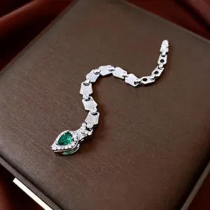 Elegant silver snake ring with pear-cut emerald gemstone and sparkling cubic zirconia