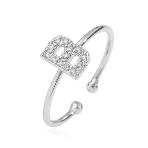 Detail of silver open ring featuring a sparkling zircon letter B set on a polished band