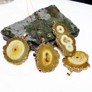 Natural solar quartz pendant with gold plated brass edge and crystalline sunburst texture