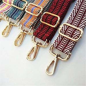 Detailed close-up of wide ethnic style replacement bag straps with golden swivel hooks