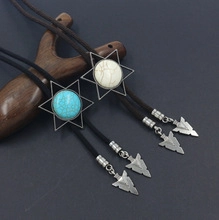 Detail of western bolo tie with hexagram turquoise pendant and black braided cord