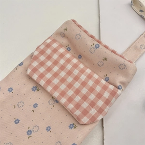 Macro detail of floral canvas nurse pen pouch with vintage red gingham front pocket