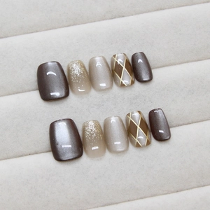 Checkered cat-eye press-on nails in coffee brown and champagne gold mix with fine shimmer