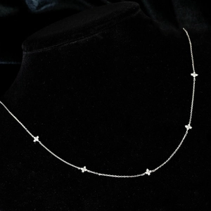 Silver flower necklace with micro-paved zircons displayed on a black velvet neck bust