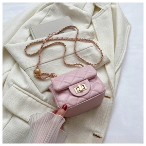 Detail of pink quilted mini crossbody bag with golden twist lock and chain strap
