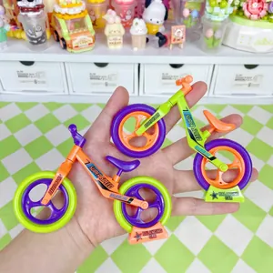 Miniature toy bicycle and balance bike models on display stands with vibrant colors