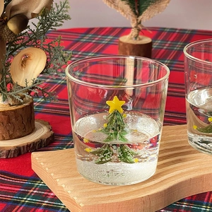 Borosilicate glass cup with a green 3D Christmas tree inside and a yellow star topper