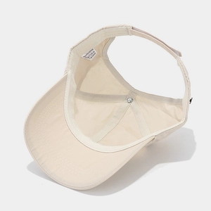 Internal view of beige ponytail baseball cap with breathable mesh and sweatband