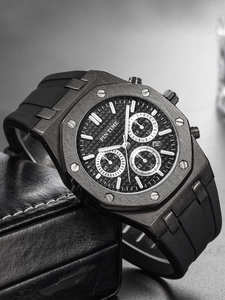 Detail of black multi-function chronograph watch with octagonal bezel and rubber strap