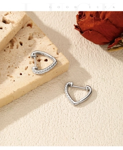 Detail of S925 sterling silver heart hoop earrings with sparkling moissanite stones