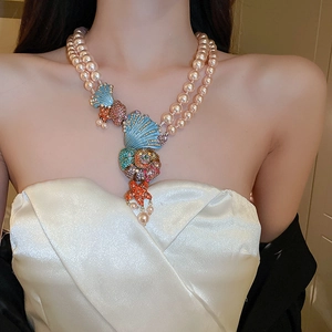 Detail of double-layer pink pearl necklace with colorful starfish and seashell charms