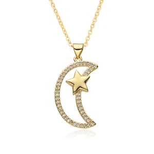 Macro shot of gold sun and moon necklace pendant with sparkling paved zircon stones
