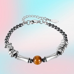 Silver stainless steel bamboo link bracelet with a brown volcanic stone bead centerpiece