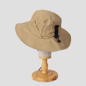 Outdoor khaki nylon wide brim sun hat with adjustable drawstring on wooden head stand