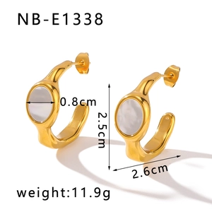 Macro detail of vintage gold C-shaped earrings with white shell inlay and measurements
