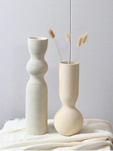 Macro view of matte ceramic vase showing detailed horizontal brushed texture and artistic finish