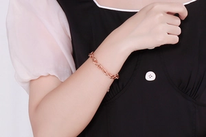 Close-up of rose gold infinity symbol bracelet on a female wrist with delicate chain